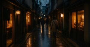 A narrow Japanese shopping street at dusk with lit shopfronts
